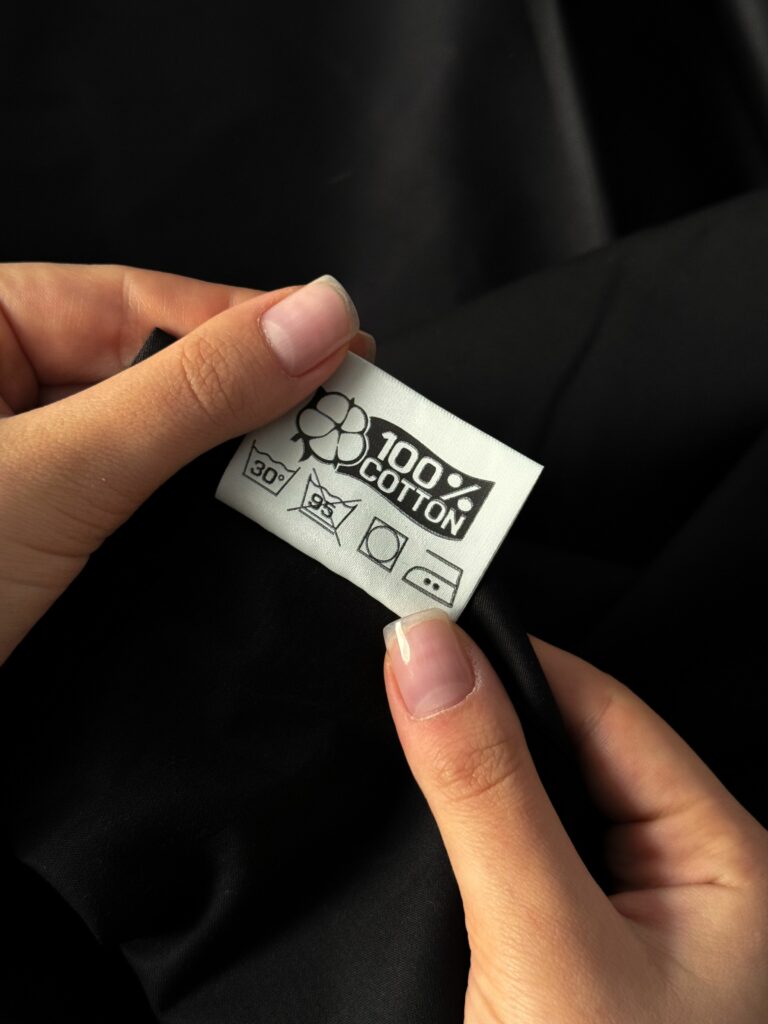 Étiquette de vêtement présentant les symboles des cycles de lavage et d’entretien textile